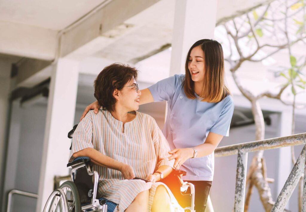 Woman in wheelchair talking with nurse